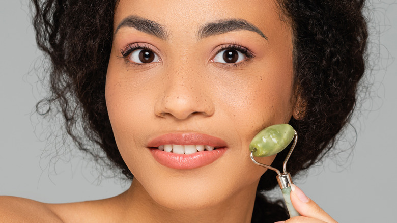 Two women using jade rollers