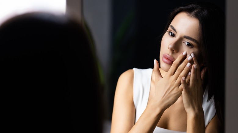 woman looking in mirror
