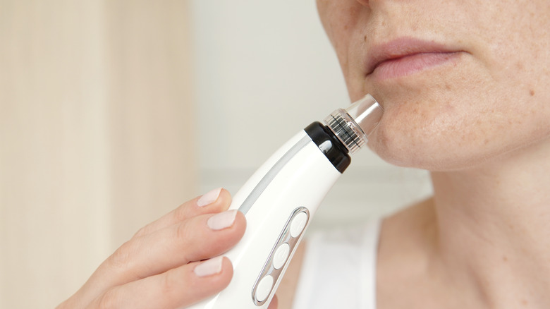 woman using pore vacuum 