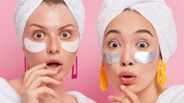 two women wear patches on their under eye areas