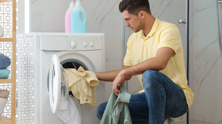 man taking clothes out of the dryer