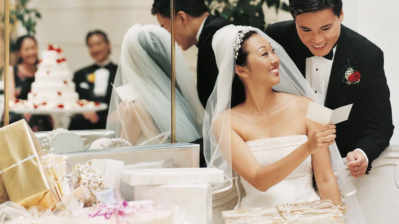 couple opening wedding gifts