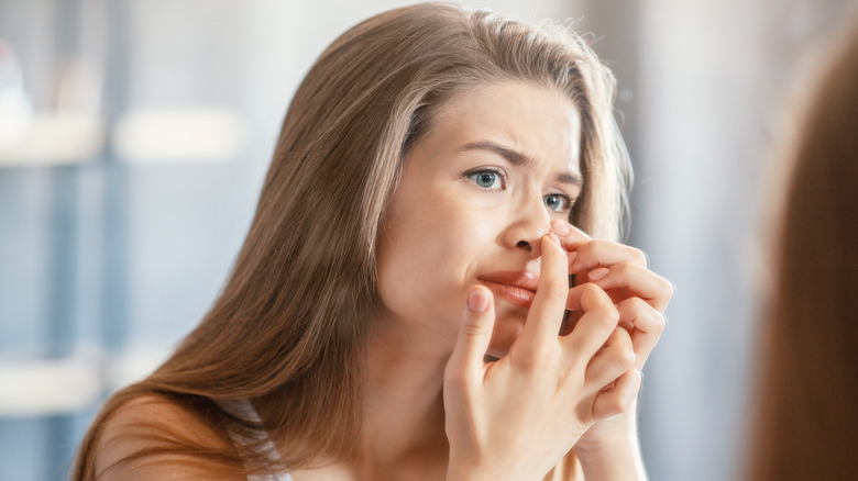 woman touching her nose