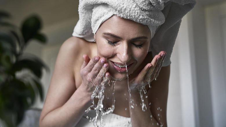 woman washing her face