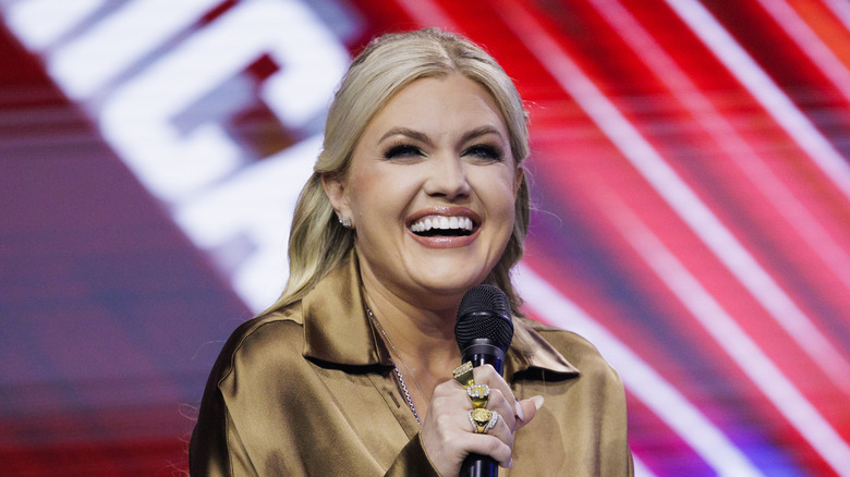 Erika Kirk laughing into a microphone on stage