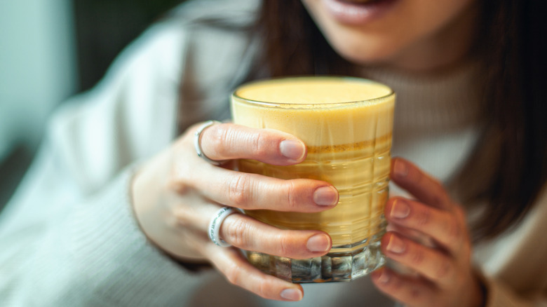 Woman holding golden milk 