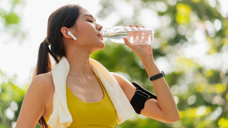 exercising woman drinking water