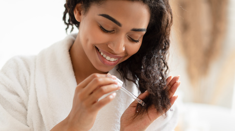 Woman applying hair products
