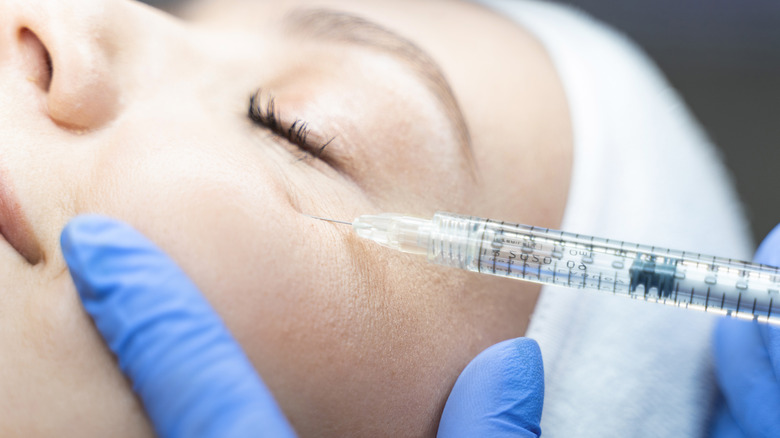 woman receiving under eye injection