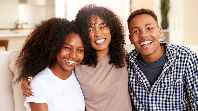 Three siblings smiling