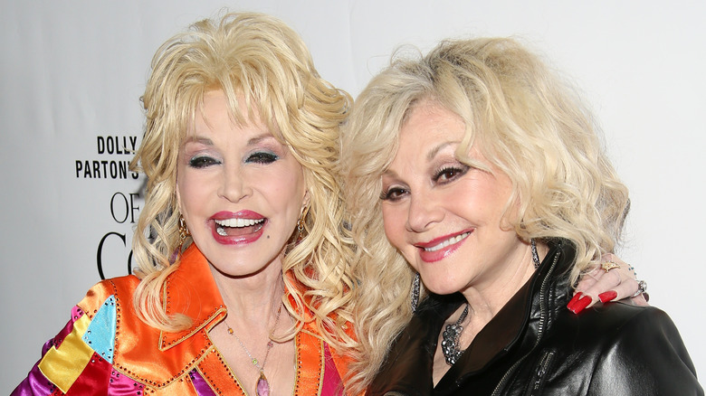 Dolly Parton poses with sister Stella Parton during a red carpet photo-op.