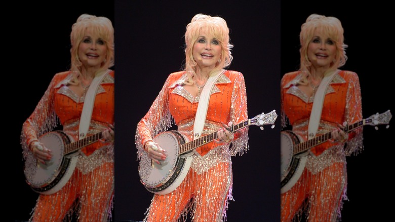 Dolly Parton performs onstage for a 2014 Dolly's Imagination Library benefit.