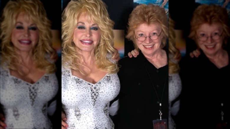 Dolly Parton (left) with Judy Ogle (right) wearing a black shirt with a ginger bouffant