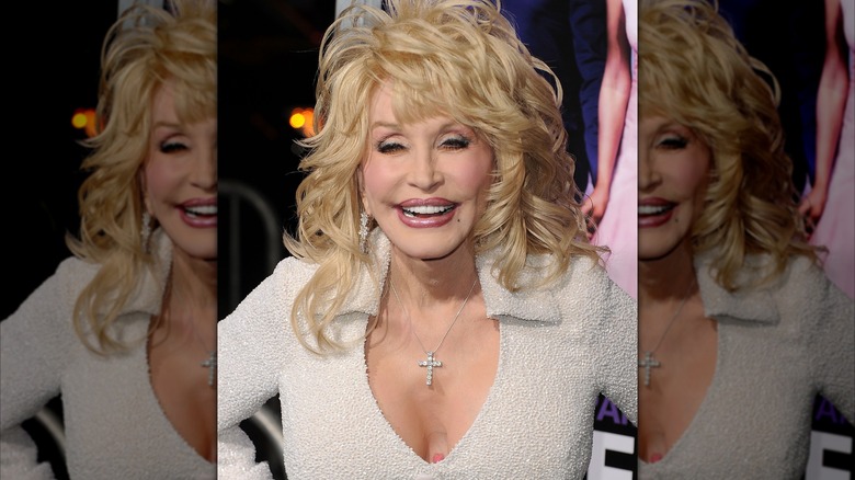 Dolly Parton shows glimpse of chest flower tattoo at Joyful Noise premiere in 2012.