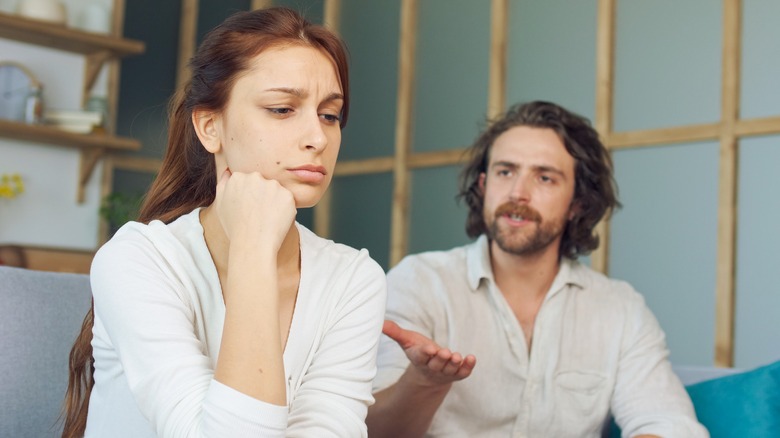 Couple looking upset on couch