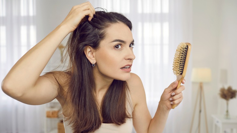 woman looking concerned at hair