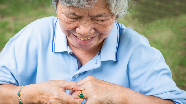 Woman struggling with stuck ring