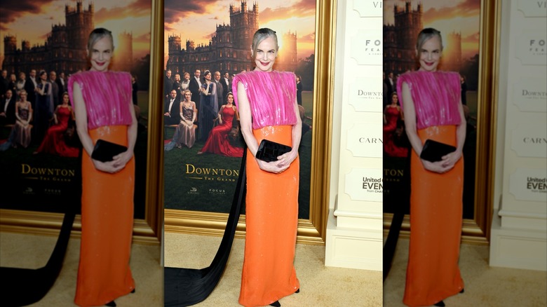 Elizabeth McGovern pictured in 2025 wearing an orange, pink, and black gown to the ﻿﻿﻿"Downton Abbey: The Grand Finale" premiere