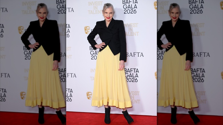 Elizabeth McGovern pictured in 2026 wearing a pastel yellow dress and black blazer
