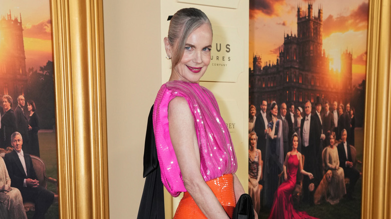 Elizabeth McGovern pictured in 2025 wearing an orange, pink, and black gown to the ﻿﻿﻿