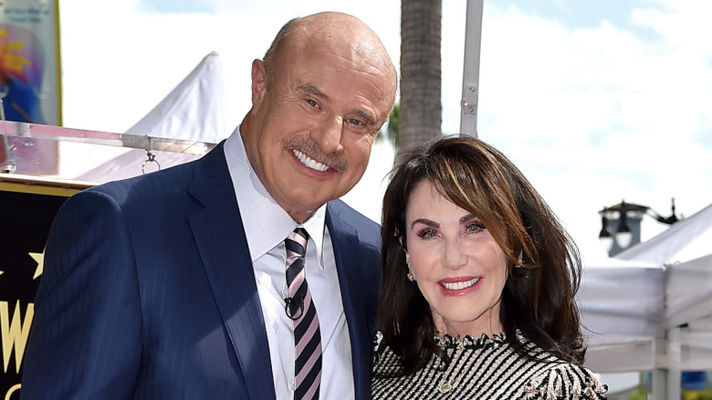 Dr. Phil McGraw and his wife Robin McGraw posing for a photo on his Star on the Hollywood Walk of Fame