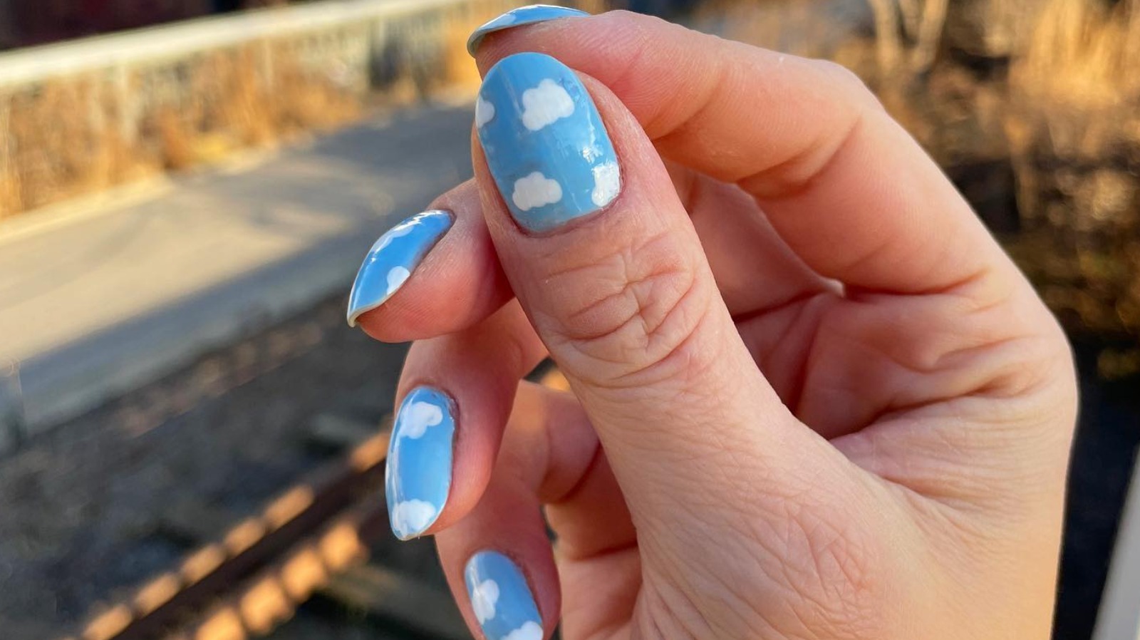 7. Peach and pastel rainbow nails with a single cloud design - wide 7