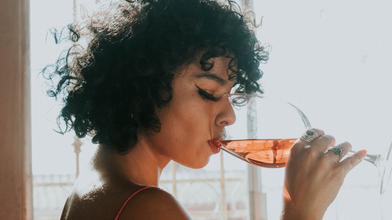 female drinking wine