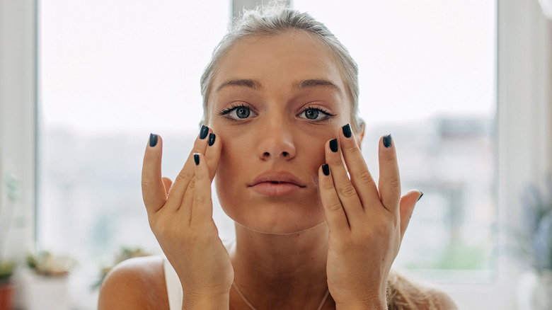 Woman pressing undereyes