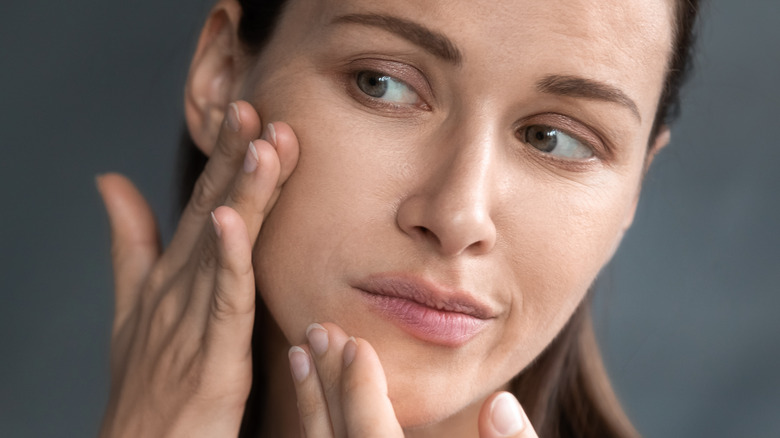woman touching skin