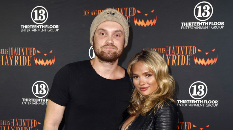 Natalie Alyn Lind and Kai Caster wearing black outfits