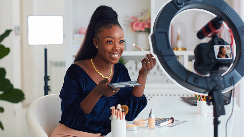 woman applying makeup