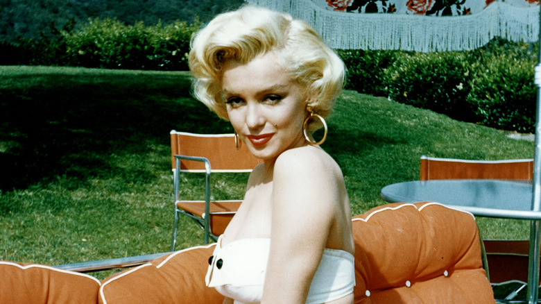 Marilyn Monroe with gold hoop earrings and a white top