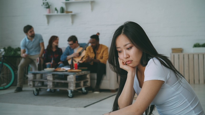 woman upset in group conversation