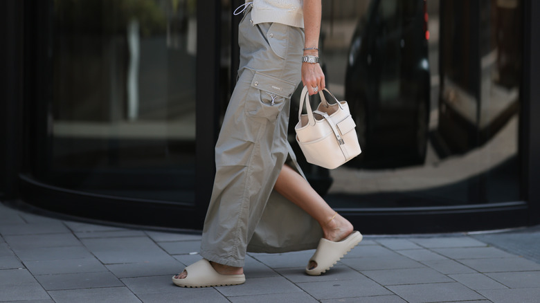 Stylish woman walking in rubber slides