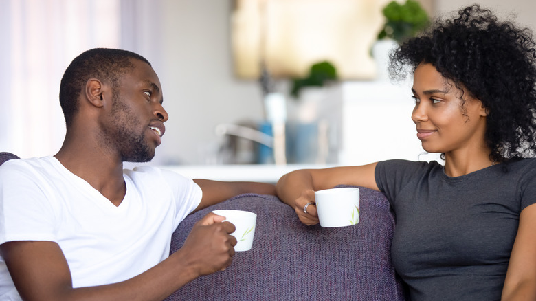 A couple drinking coffee and talking