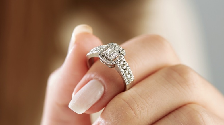 woman holding engagement ring