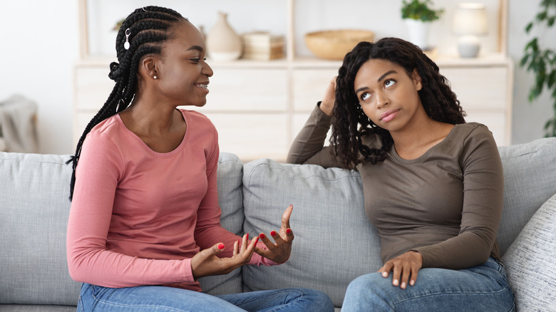 woman rolling eyes at other woman