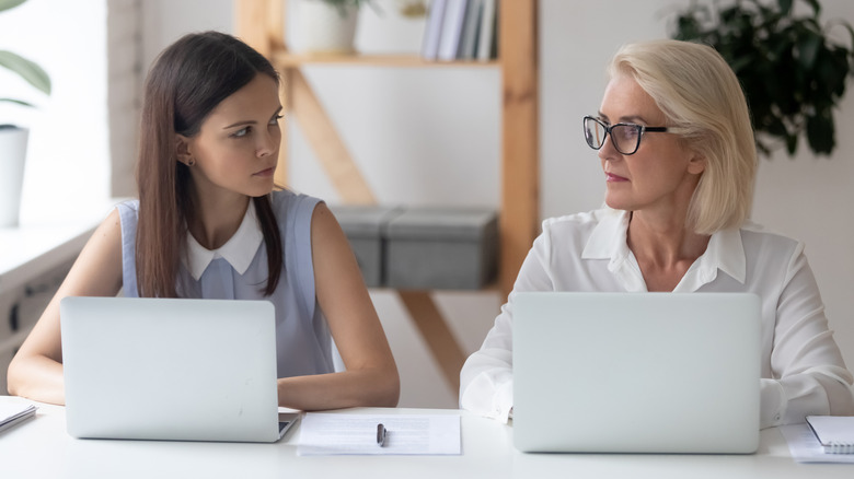 two women eyeing each other