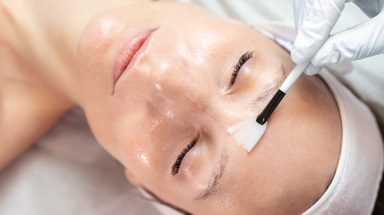 Woman applying face mask