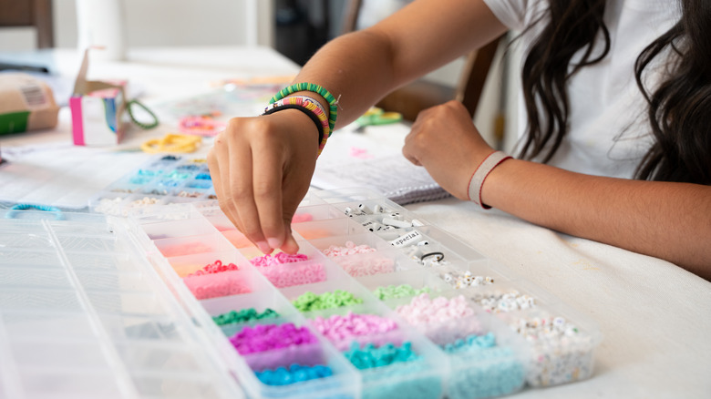 Person making friendship bracelets