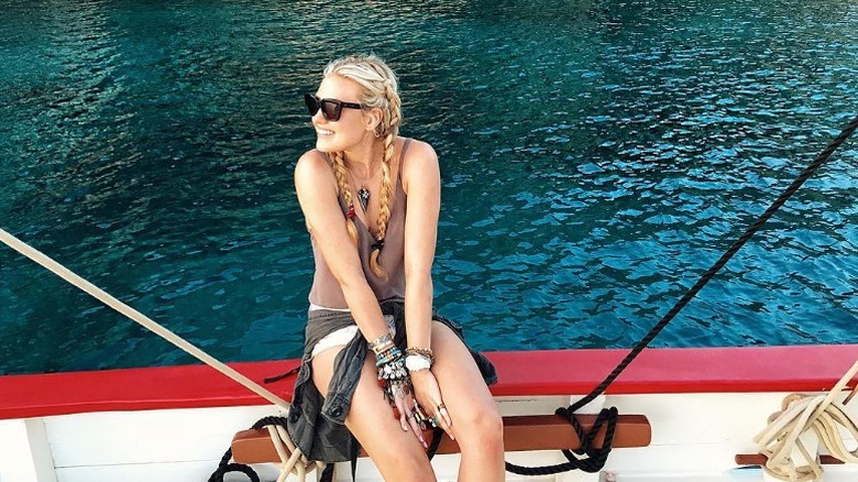 Erika Kirk sits on the side of a boat