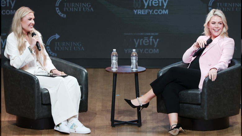 Erika Kirk and Karoline Leavitt sit across from each other onstage at the Turning Point USA event.