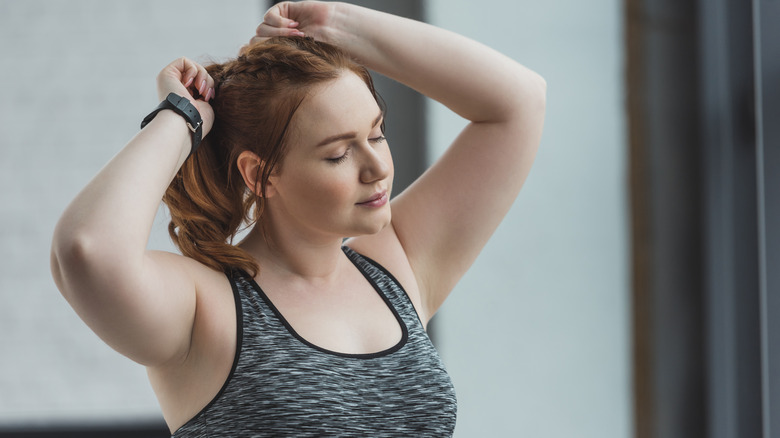 Woman tightening her ponytail