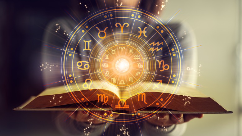 The zodiac calendar on an open book.