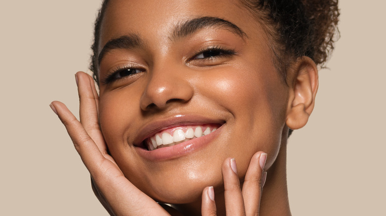 Woman with glowing skin, smiling