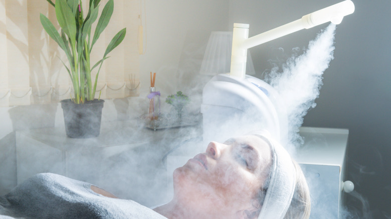 Woman receiving a facial steam 