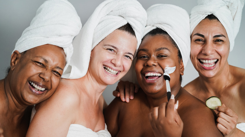 Four women with their hair wrapped in towels