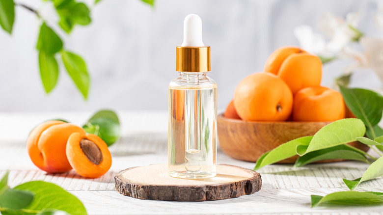 oil bottle with apricots in background