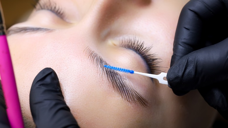 A woman getting her eyebrows laminated