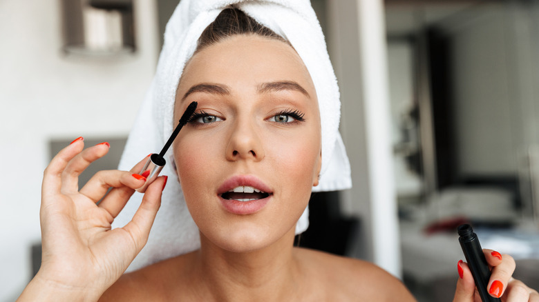 Woman applying mascara 